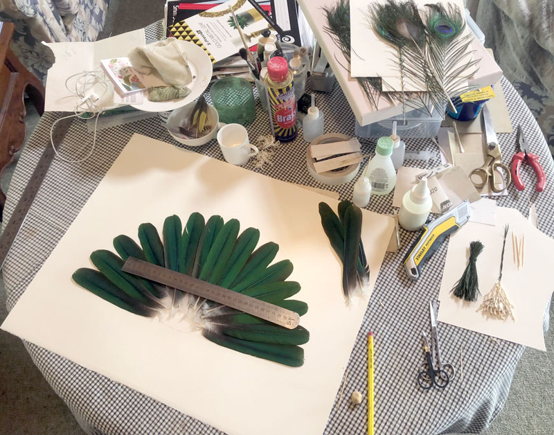 Feather wall art - work in progress on the table